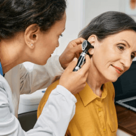 A doctor examining a patient's ear