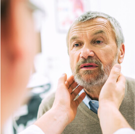 A doctor examining a patient's neck