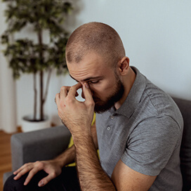 A man pinching the bridge of his nose