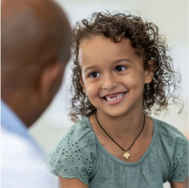 A child smiling at a doctor