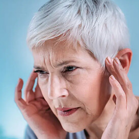 A women plugging her ears