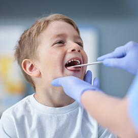 A child being examined with a tongue depressor