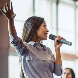 A women with a microphone presenting